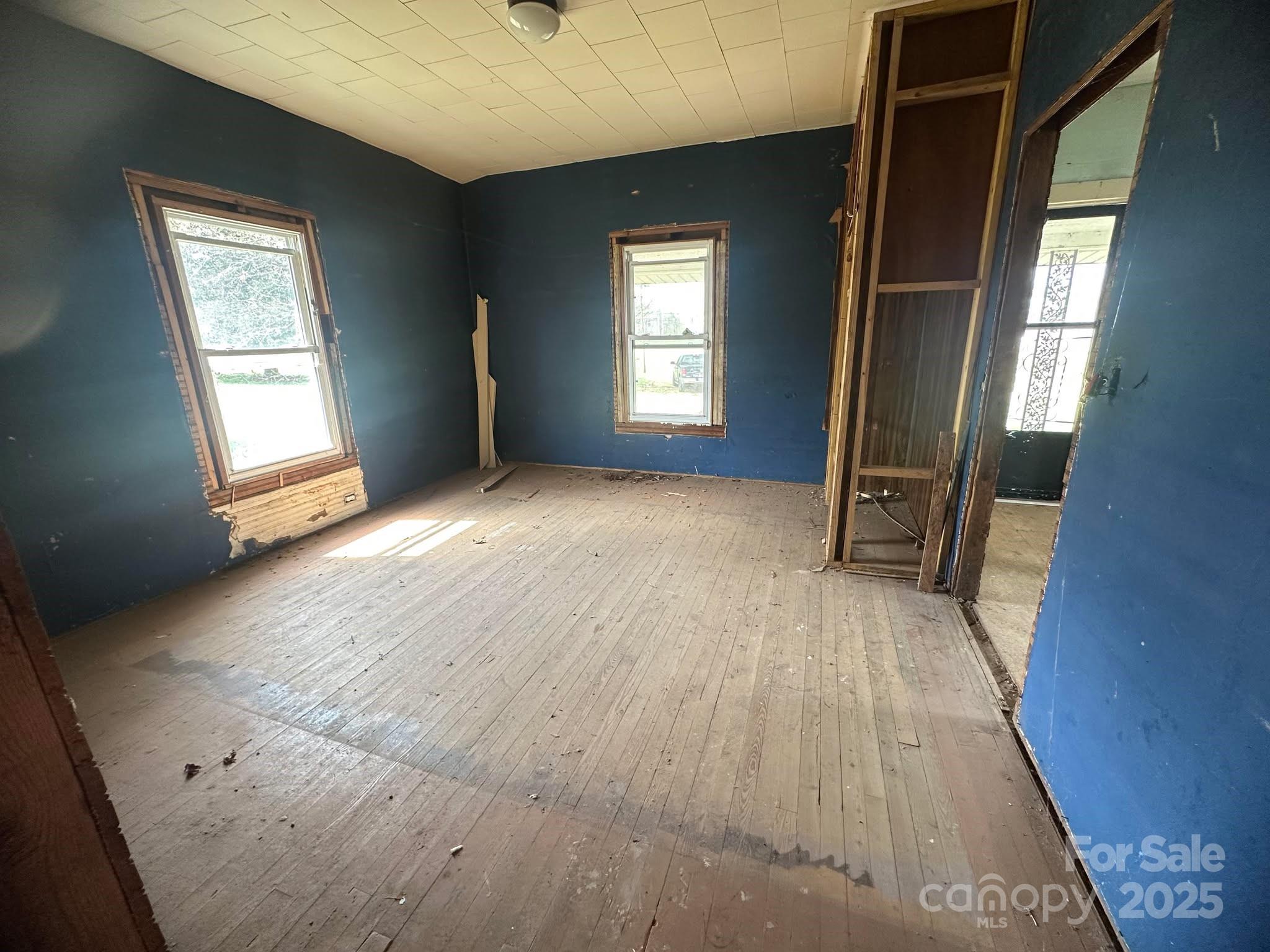 4349 Roberta Road Concord, NC 28027 - Photo 23 of 25 an empty room with wooden floor and windows