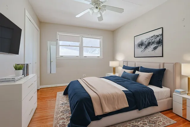 a bedroom with a large bed and a chandelier