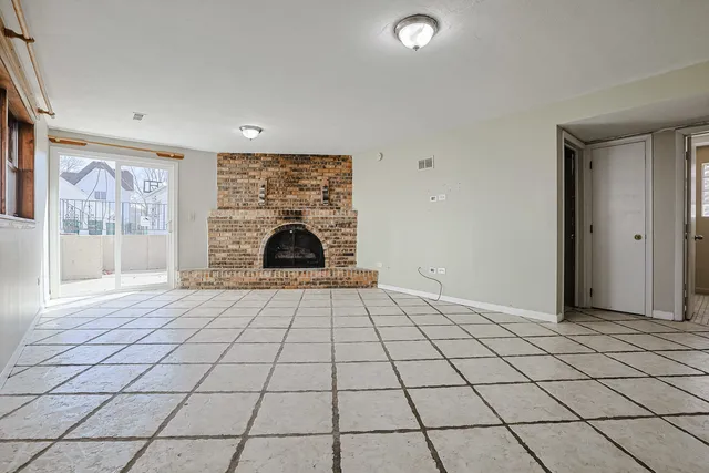 a view of an empty room with a fireplace
