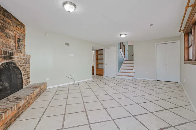 a view of an empty room with stairs and ventilation