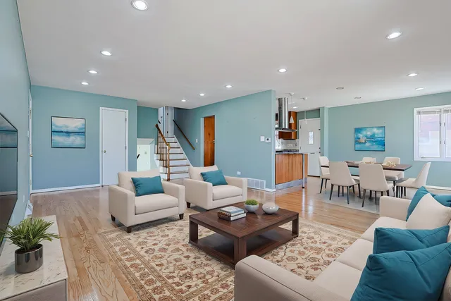 a living room with furniture and wooden floor