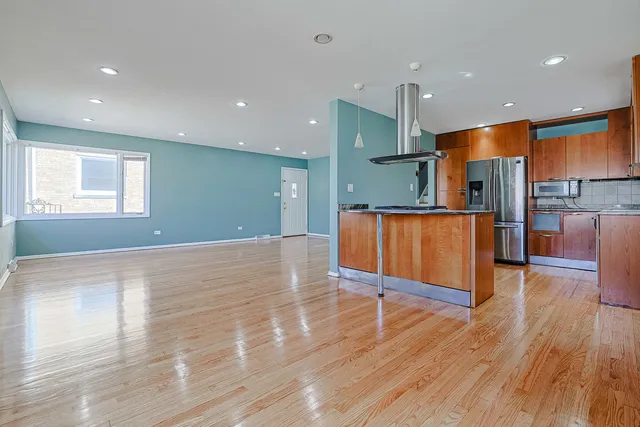 a view of kitchen with cabinets and wooden floor