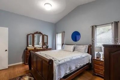 a bedroom with a bed and a table with mirror