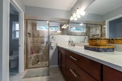 a bathroom with a sink double vanity and a shower