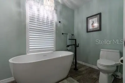 a white bath tub sitting next to a white toilet