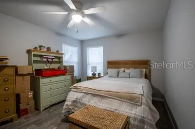 a bedroom with a bed and a chandelier