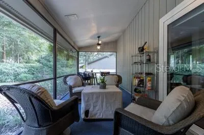a living room with furniture and a floor to ceiling window