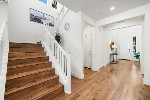 a view of entryway and hall with wooden floor
