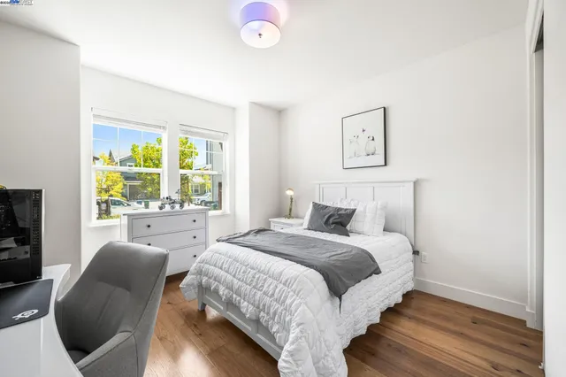 a bedroom with a large bed and a window