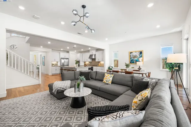 a living room with furniture and a view of kitchen
