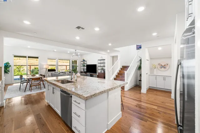a kitchen with a stove a refrigerator and a sink