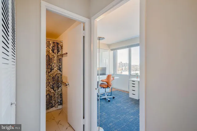 a view of a room that has a bed and chair