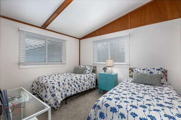 a bedroom with two beds and a window