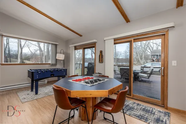 a dining room with furniture and wooden floor