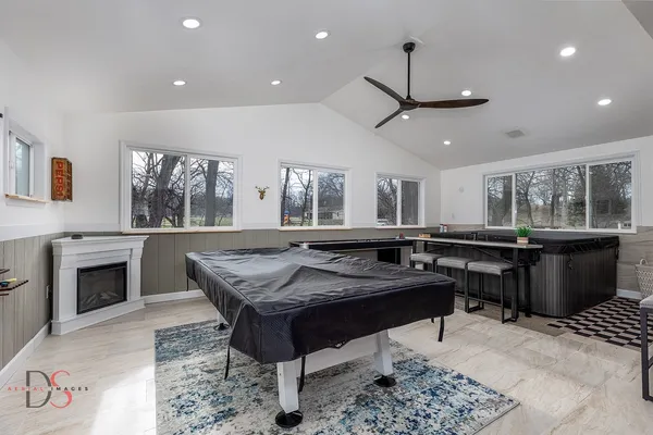 a kitchen with a stove a counter space a sink dining table and chairs
