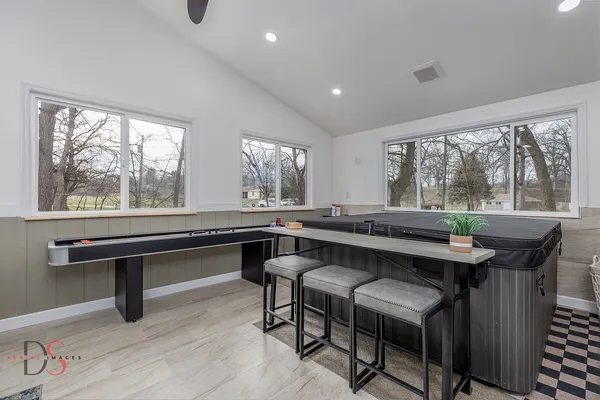 a room with a wooden table and chairs