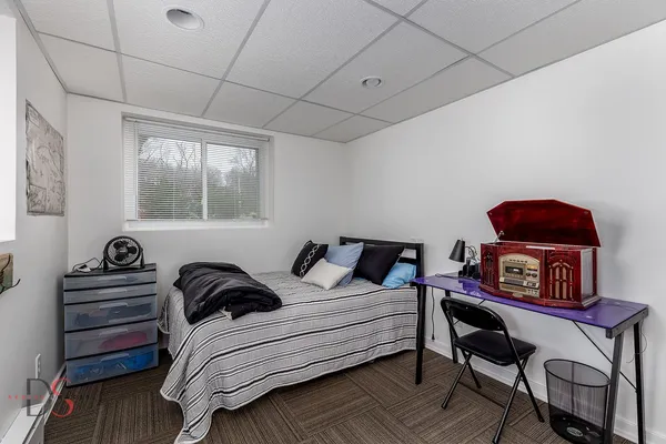 a bedroom with furniture and a book shelf