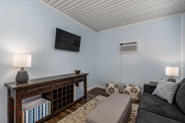 a bedroom with furniture and a flat screen tv