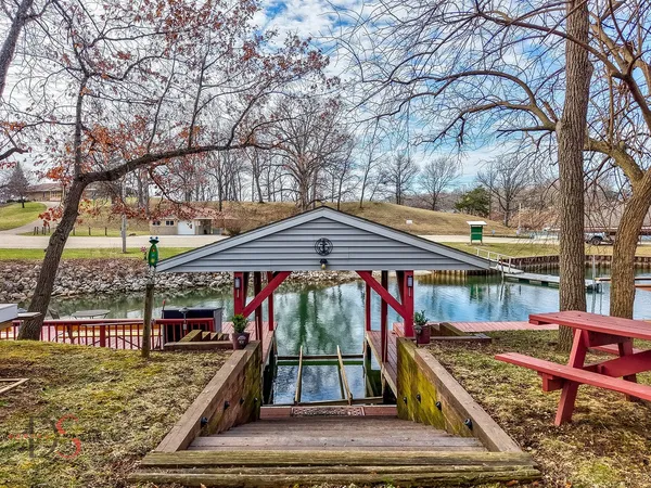 a front view of a house with swimming pool table and chairs