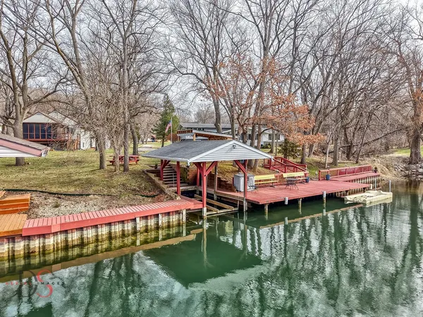 a view of swimming pool with outdoor seating and lake view