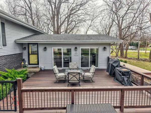 a view of a house with backyard sitting area and garden