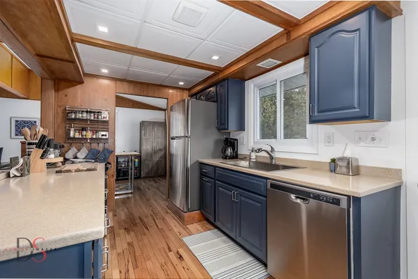 a kitchen with sink cabinets and wooden floor