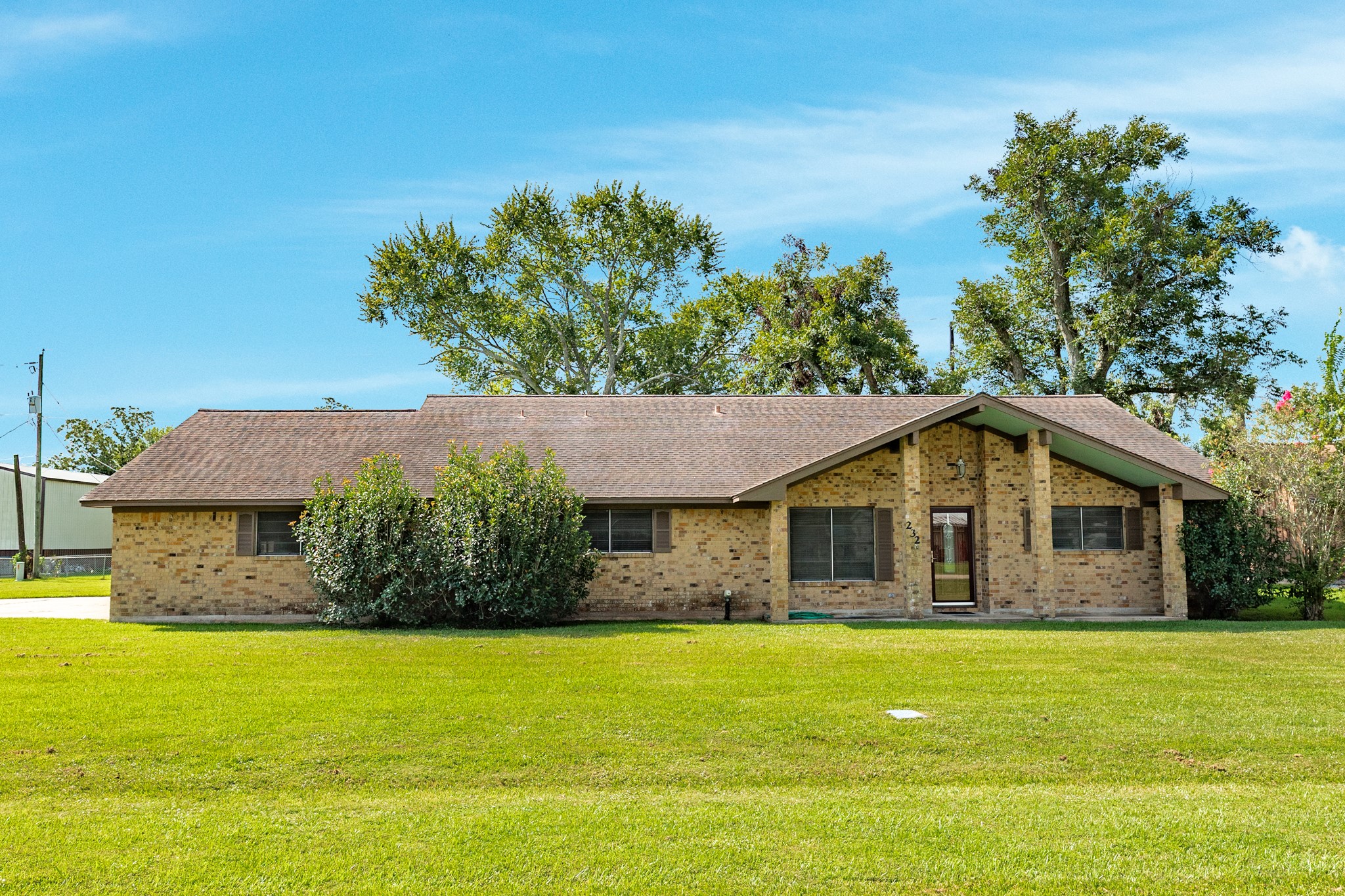a front view of a house with a garden
