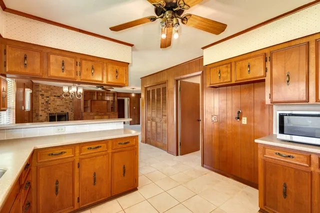 a view of a kitchen with stainless steel appliances granite countertop cabinets and a window