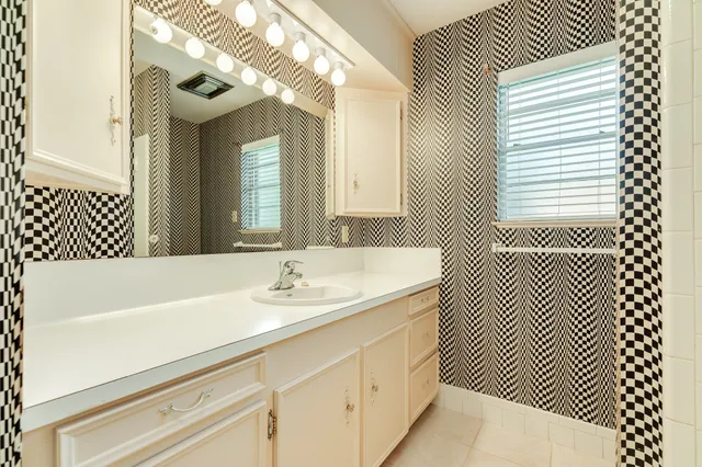 a bathroom with a sink a mirror and a bathtub