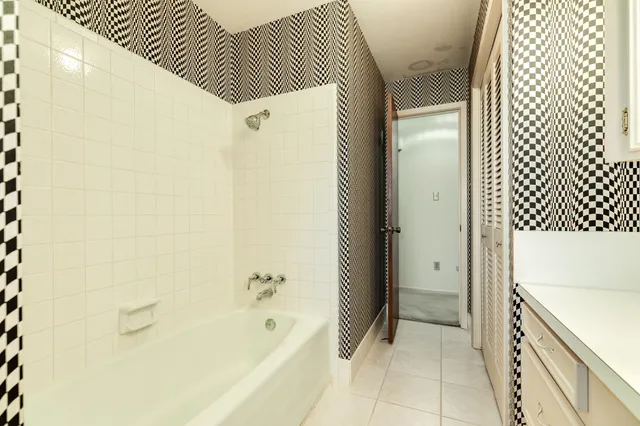 a bathroom with a bathtub and shower