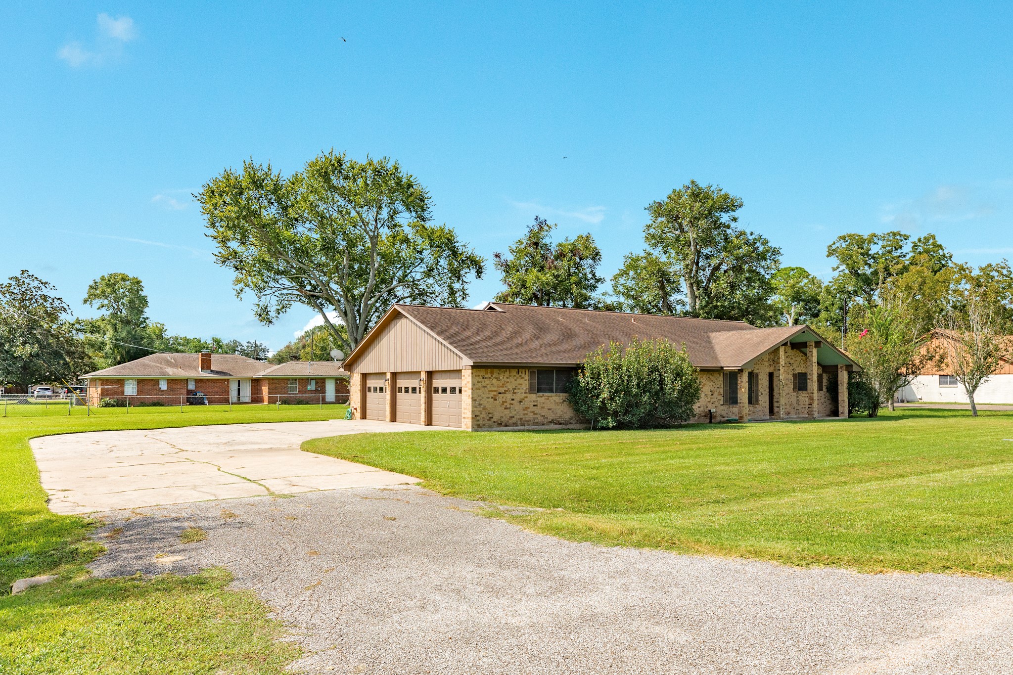 232 Magnolia Street Brazoria, TX 77422 - Photo 3 of 28 a view of a house with a big yard and palm trees