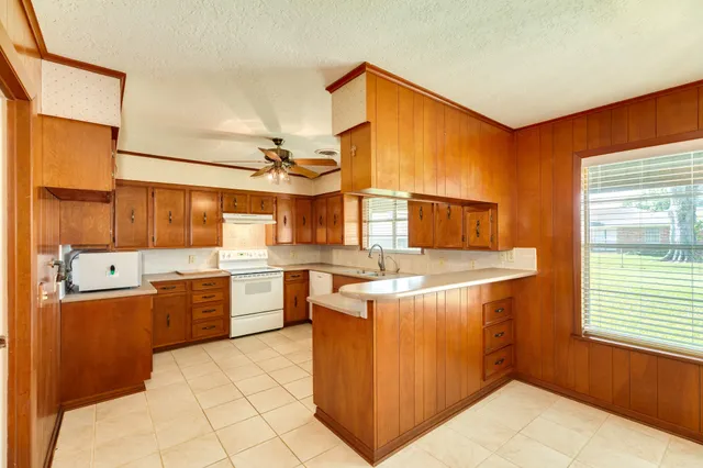 a kitchen with a stove a sink and a refrigerator