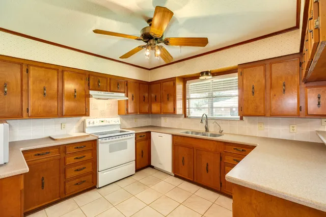 a kitchen with a sink cabinets and window