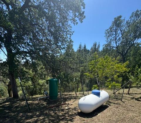 16164 Nugget Road Corning, CA 96021 - Photo 24 of 53 a view of a backyard with table and chairs and a fire pit