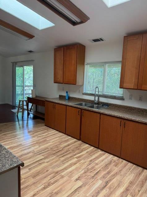 16164 Nugget Road Corning, CA 96021 - Photo 38 of 53 a kitchen with stainless steel appliances granite countertop a sink dishwasher cabinets and wooden floor