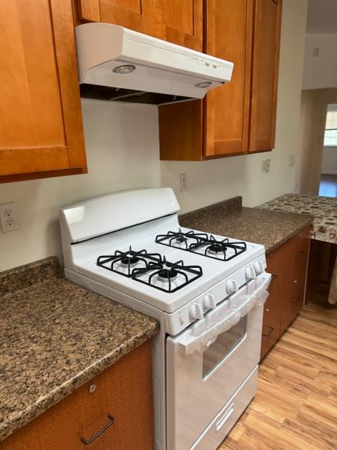 16164 Nugget Road Corning, CA 96021 - Photo 40 of 53 a white stove top oven sitting inside of a kitchen