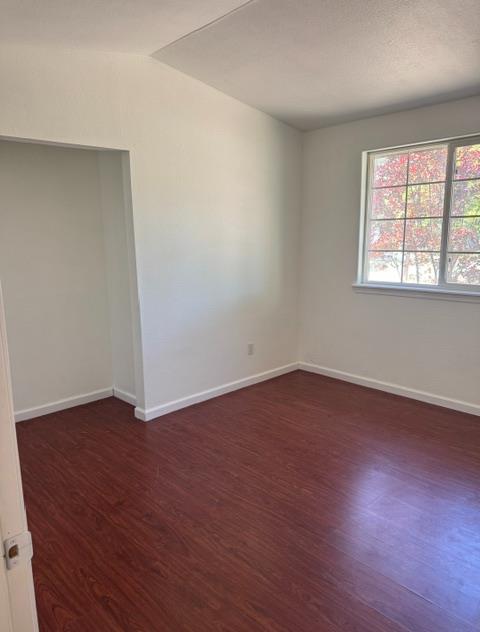 16164 Nugget Road Corning, CA 96021 - Photo 48 of 53 an empty room with wooden floor and windows