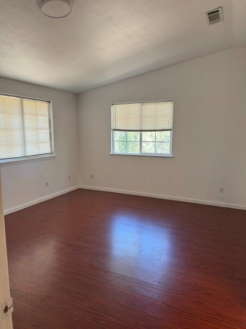 16164 Nugget Road Corning, CA 96021 - Photo 49 of 53 an empty room with wooden floor and windows