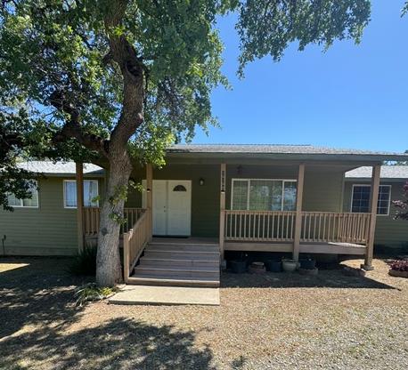 16164 Nugget Road Corning, CA 96021 - Photo 5 of 53 a view of a house with a wooden deck and a yard