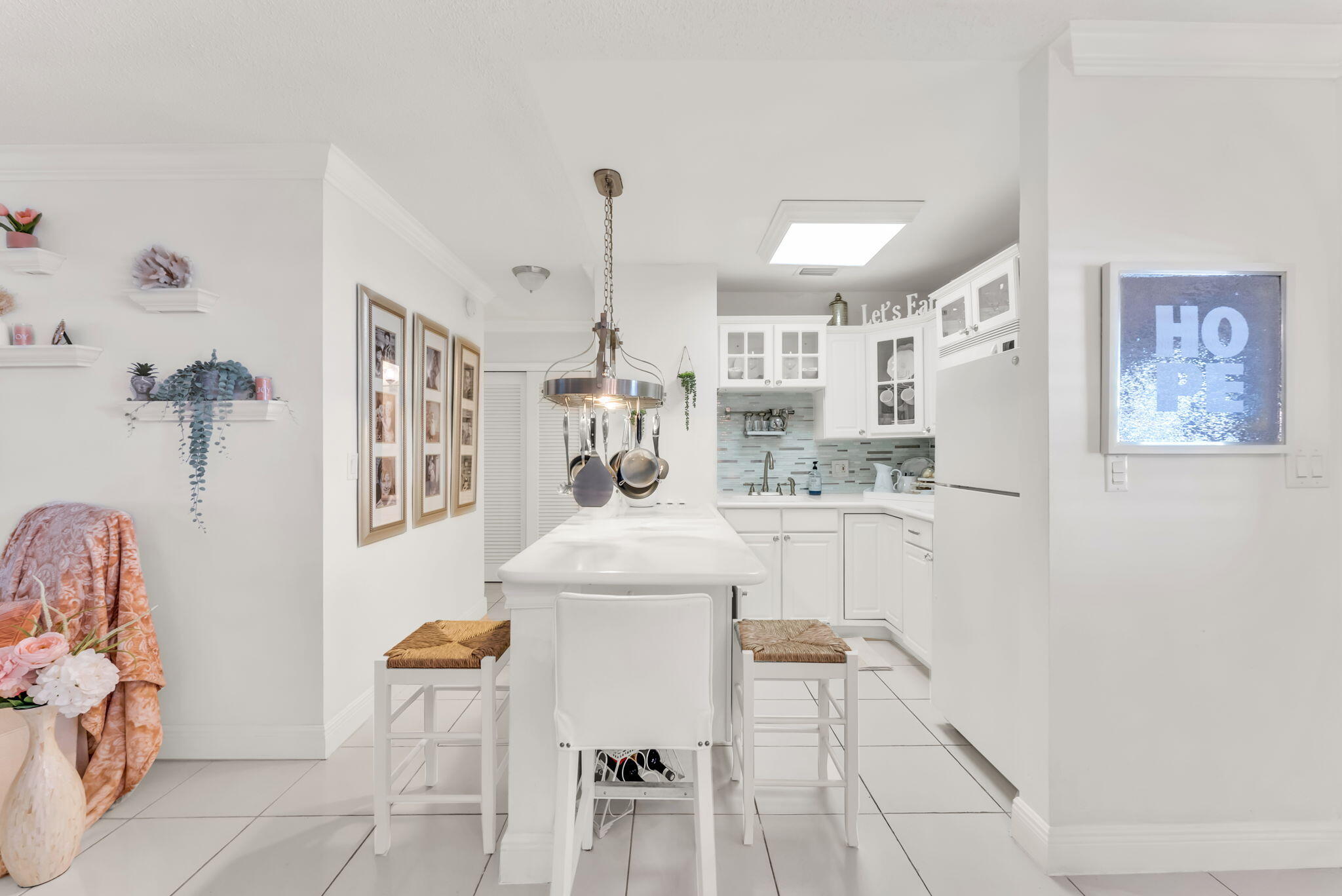 a kitchen with cabinets and chairs