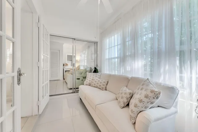 a living room with furniture and large windows