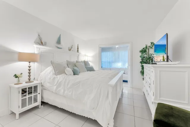 a spacious bedroom with a bed and a couch