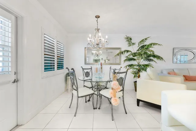 a view of a dining room with furniture and a chandelier