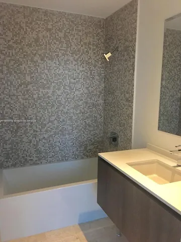 a bathroom with a bathtub and shower