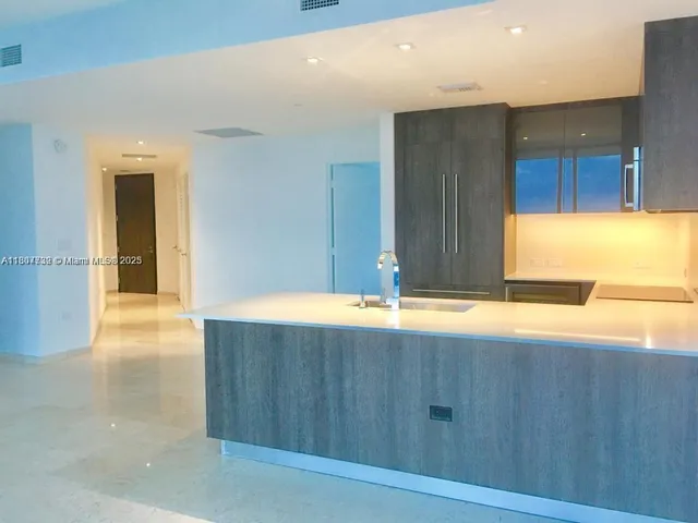 a view of a kitchen counter space and wooden floor