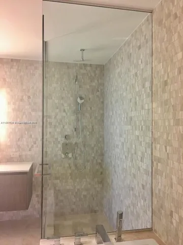 a bathroom with a shower and a bathtub