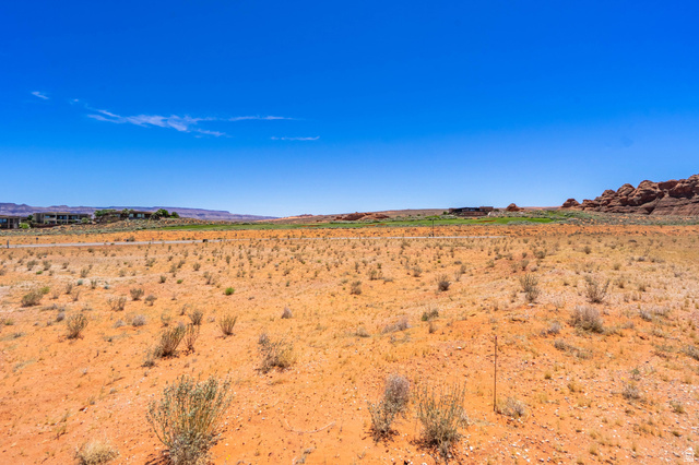 3306 South Endless Trail, Unit 33 Hurricane, UT 84737 - Photo 14 of 27 Expansive desert landscape featuring natural rock formations and distant structures under a clear sky
