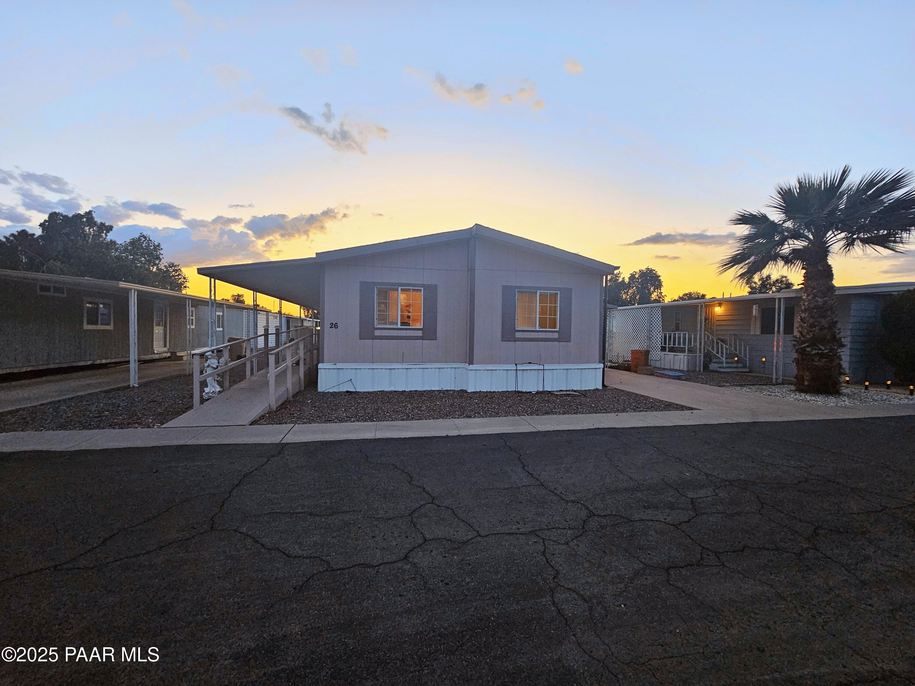 16225 North 29th Street, Unit 26 Phoenix, AZ 85032 - Photo 12 of 12 a front view of a house with a yard and garage