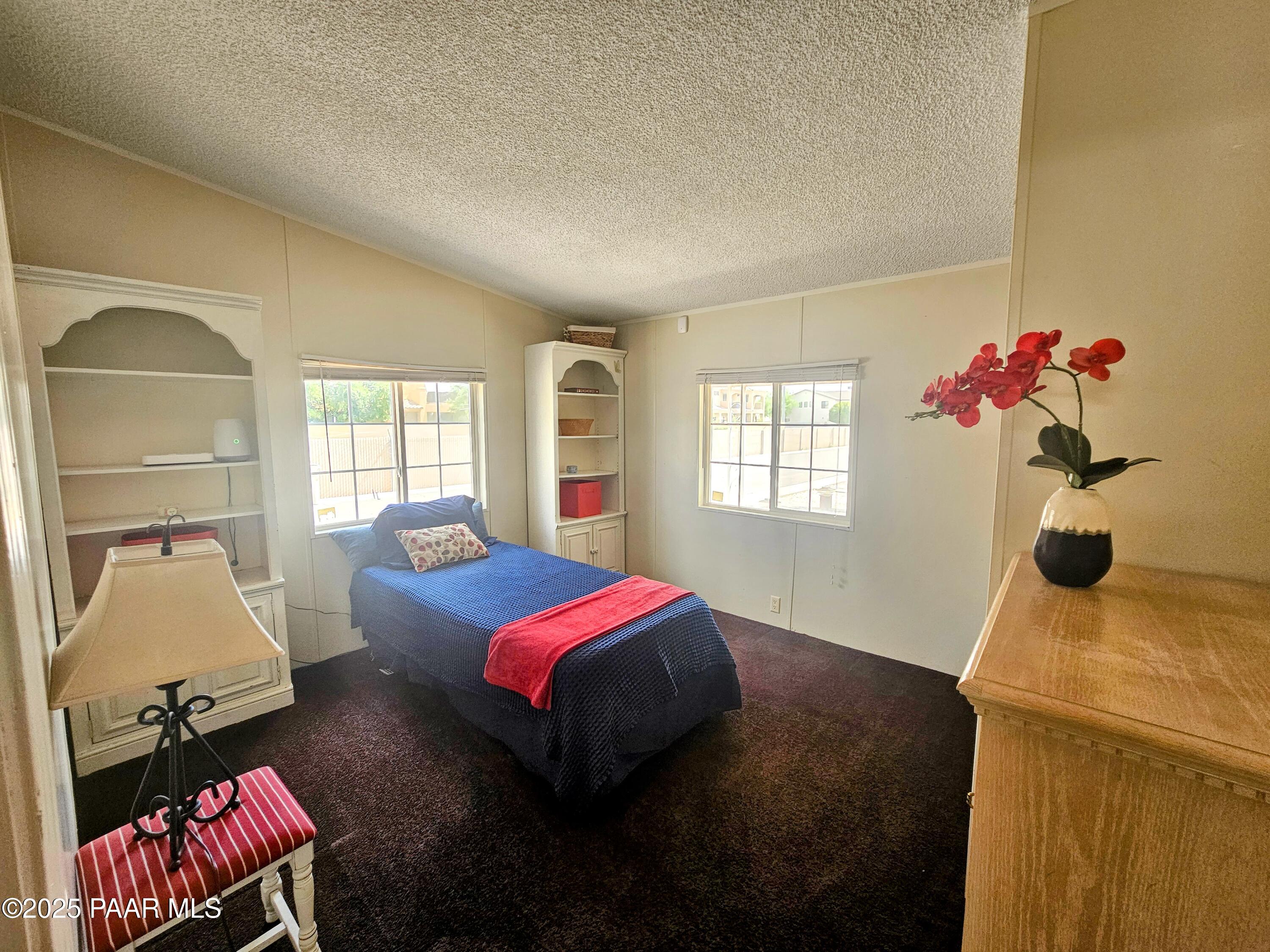16225 North 29th Street, Unit 26 Phoenix, AZ 85032 - Photo 5 of 12 a bedroom with a bed and a window