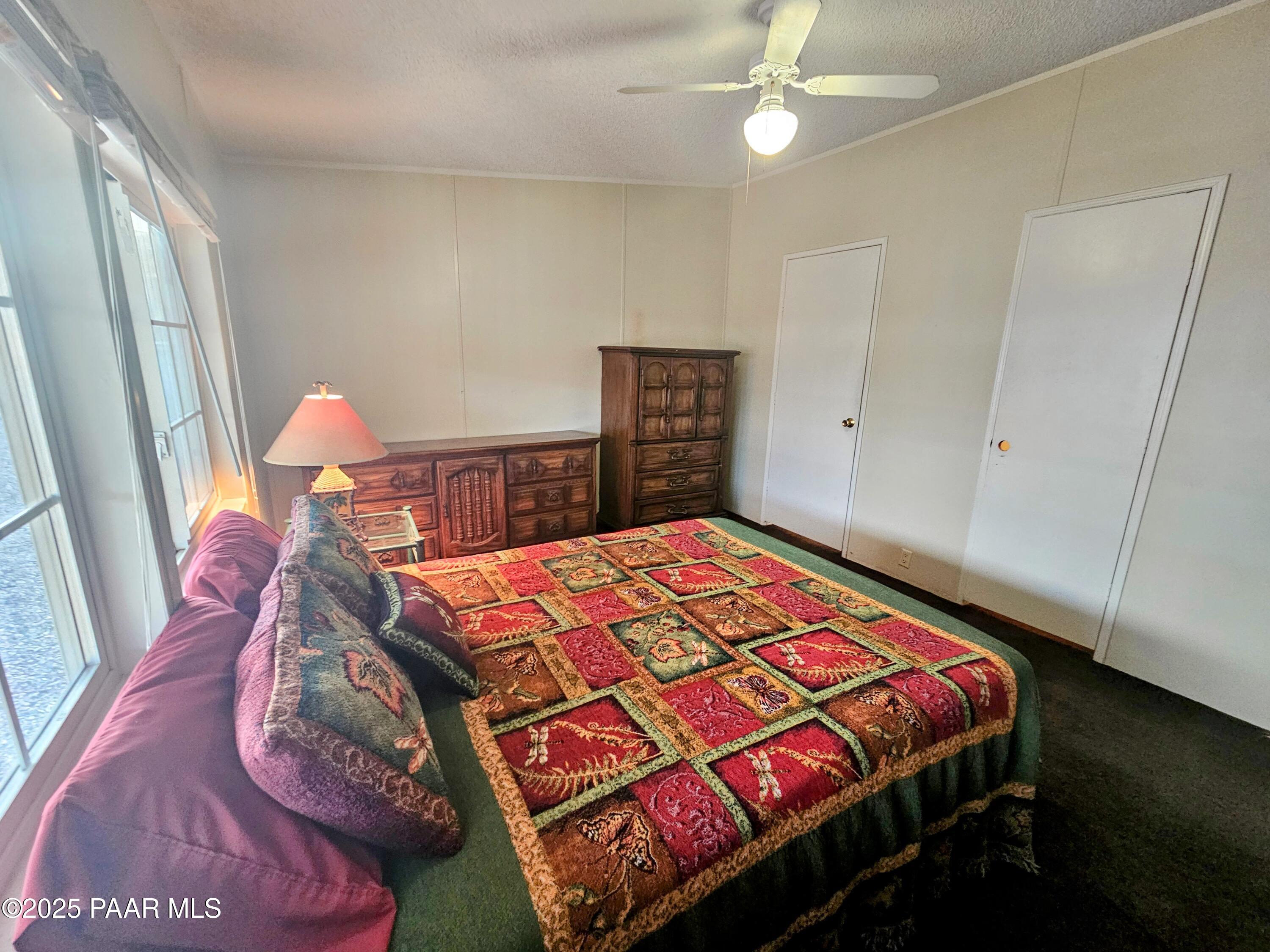 16225 North 29th Street, Unit 26 Phoenix, AZ 85032 - Photo 6 of 12 a bedroom with a bed and a dresser